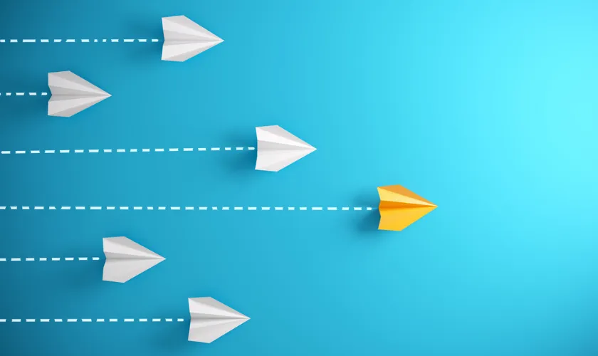 6 paper planes flying toward the right, with yellow plane in the lead_840x500.png