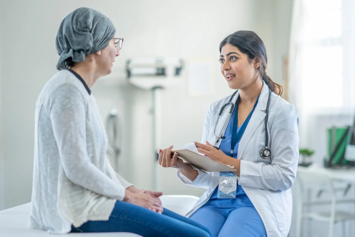 An oncologist talks with patient about palliative care upon confirmed metastatic breast cancer diagnosis
