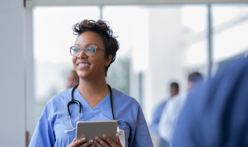 Clinician holding tablet looking to the side of room_840x500.png
