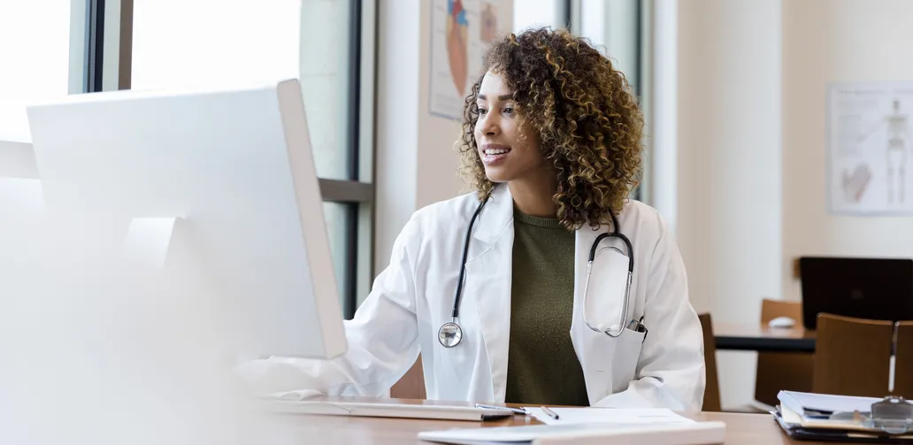 Clinician Taking an Online Course on Her Desktop Computer