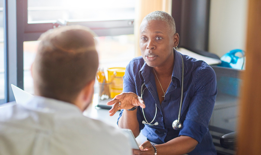 Clinician talking to patient while holding tablet