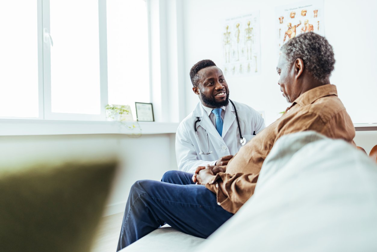 Doctor talking to older patient during a clinical exam