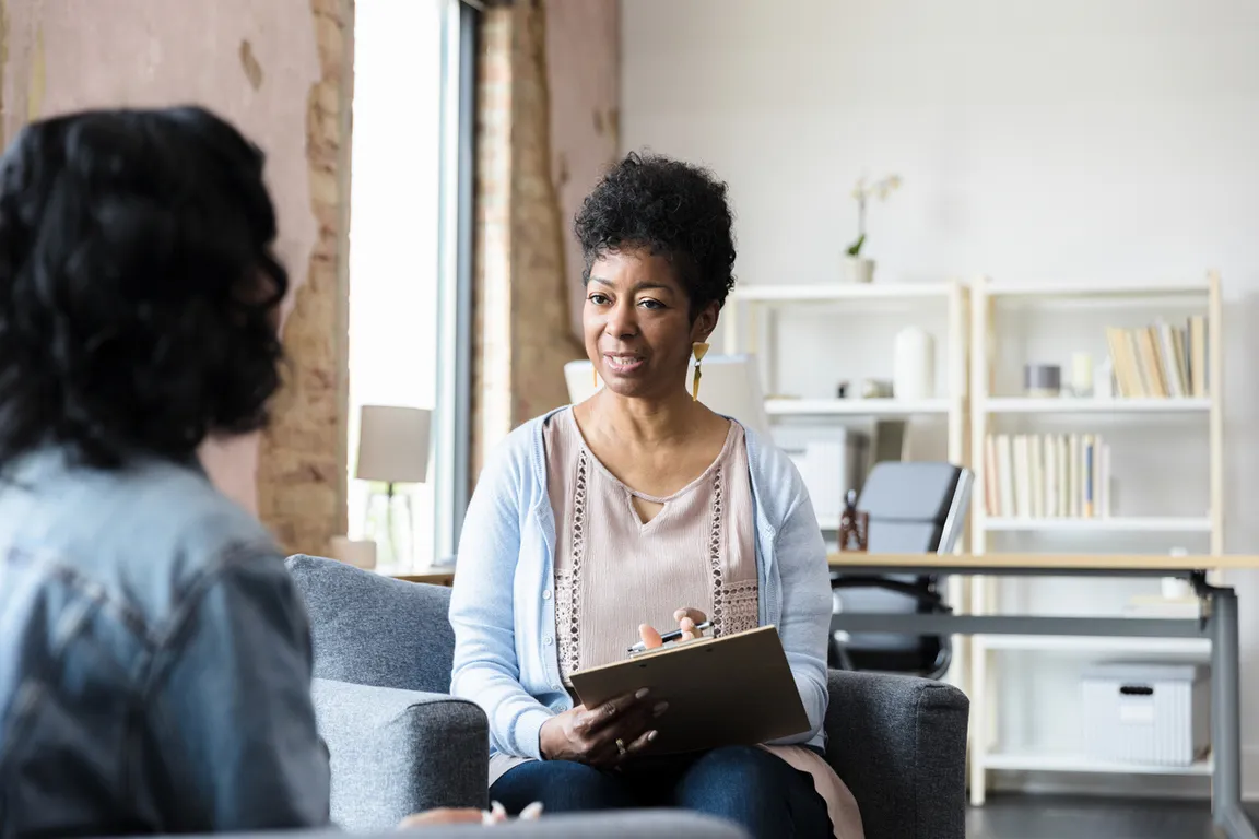 Doctor talks to patient about anxiety and depression in office_1254x836