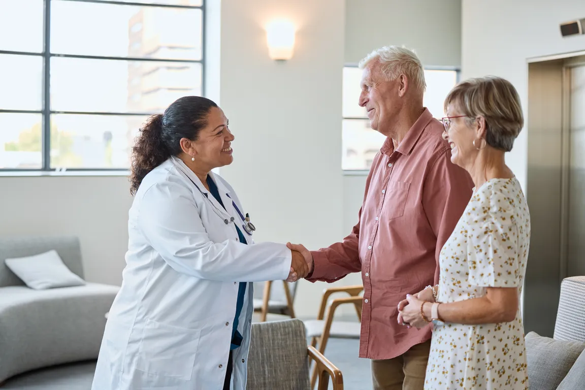 Female clinician meets patient and family in the waiting room