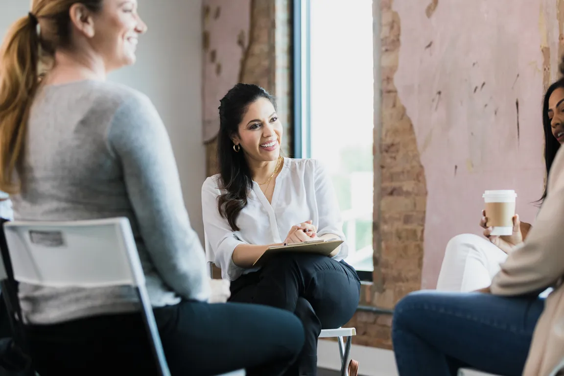 Group of clinicians sitting in a circle having a meeting