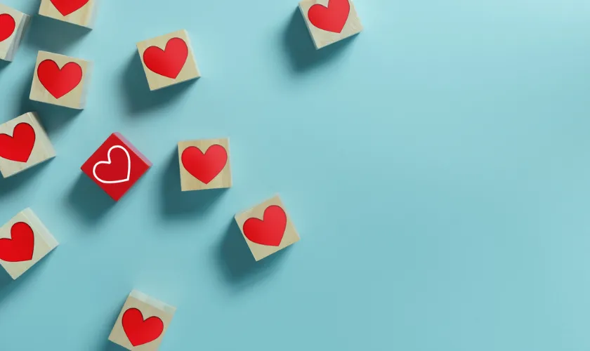 Heart Blocks Symbolizing Emotional PPE, Against Blue Background