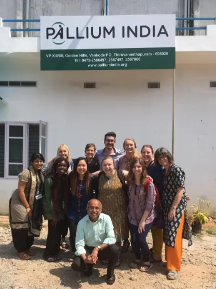 Pallium India group photo taken outside of a Pallium India clinic in Trivandrum