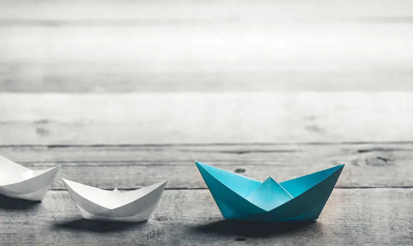 White and Blue Origami Boats Signifying Leadership