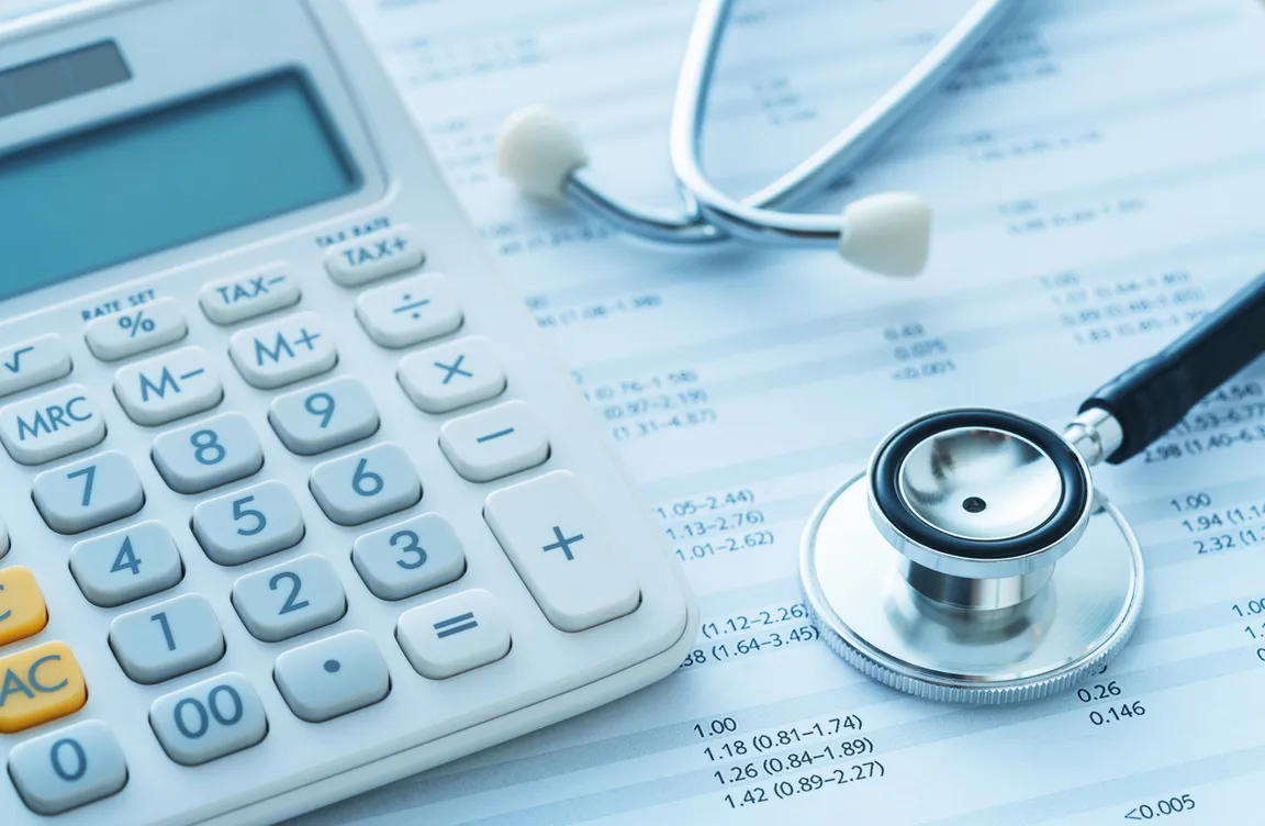 Photo of a calculator, stethoscope, and finances