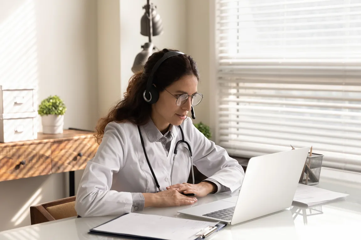 Professional female doctor wearing headphones consulting patient