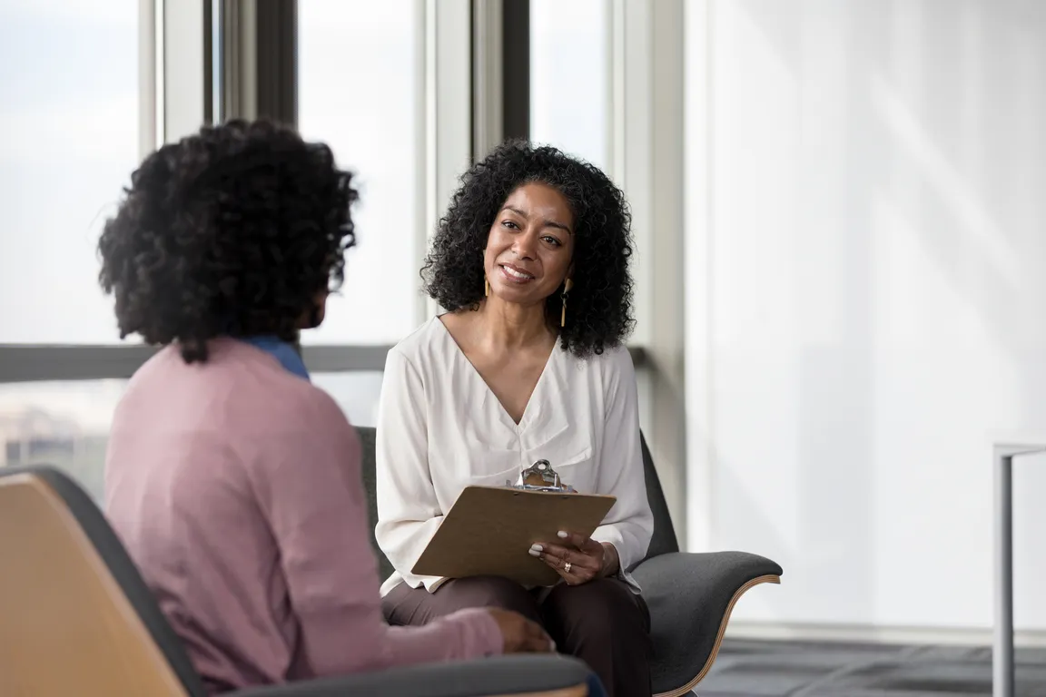 Social worker sits with patient during appointment