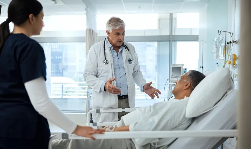 Doctor, nurse and talking with senior patient