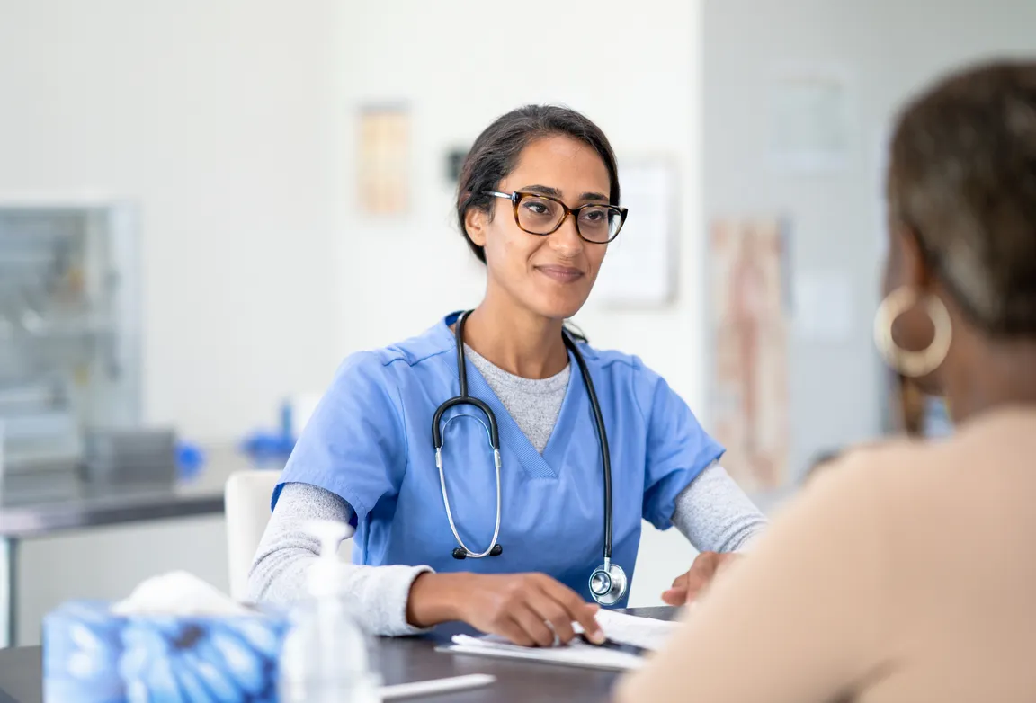 Palliative care clinician speaking to a patient with compassion
