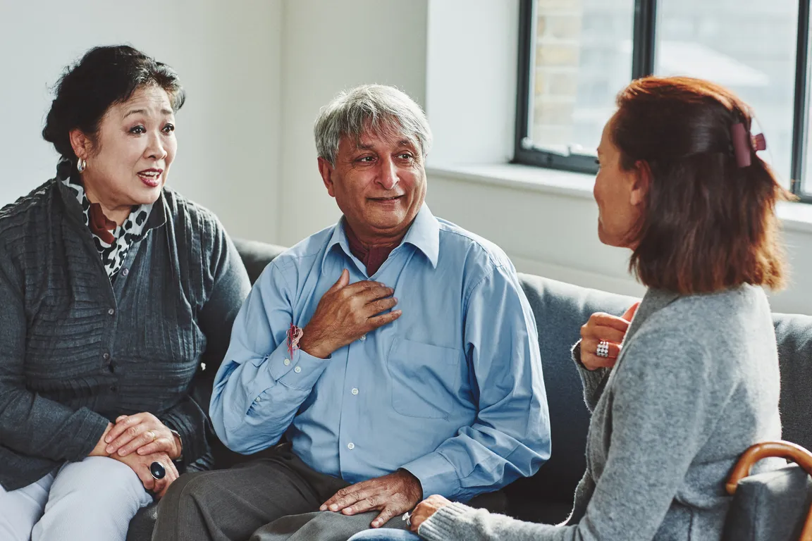 Medical Interpreters - A man and woman engage in conversation with an woman.